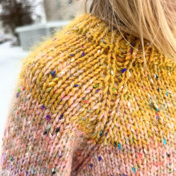 Öxl á afgangapeysu